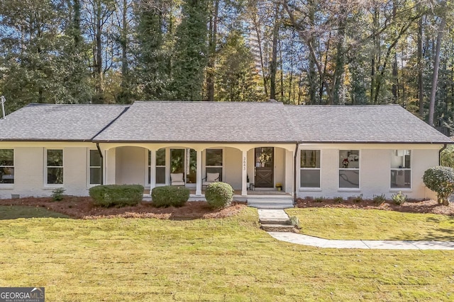 ranch-style house with a front yard and a porch