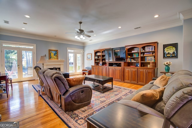 living room featuring french doors, crown molding, light hardwood / wood-style floors, and ceiling fan