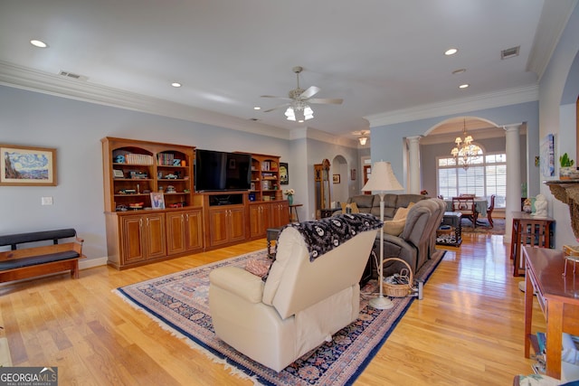 4 Bridgeview Dr SE, Rome, GA 30161 - living room with visible vents, ornate columns, arched walkways, light wood-style flooring, and ceiling fan with notable chandelier