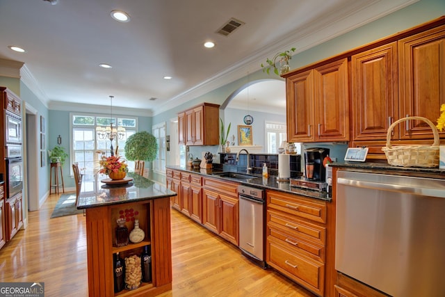4 Bridgeview Dr SE, Rome, GA 30161 - kitchen featuring visible vents, a center island, a sink, light wood finished floors, and appliances with stainless steel finishes
