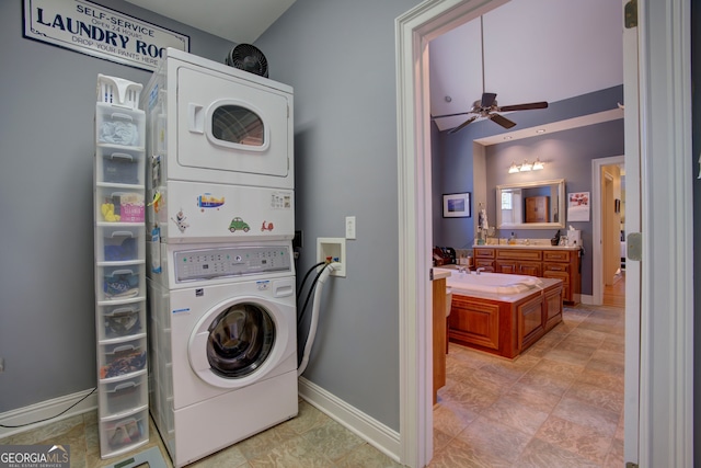 washroom with stacked washer and clothes dryer, sink, and ceiling fan