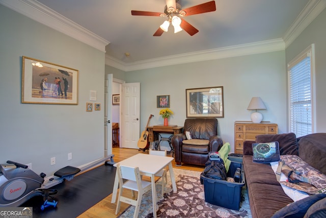 living room featuring light hardwood / wood-style floors, crown molding, and ceiling fan