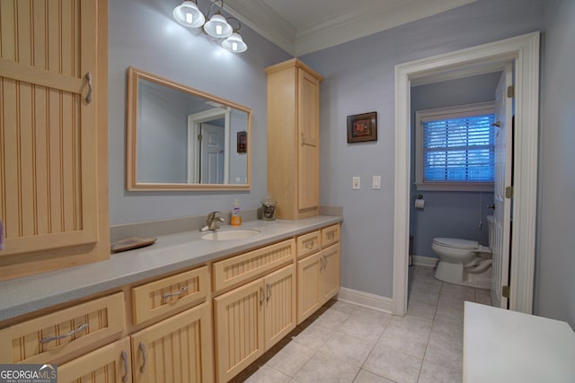 bathroom with toilet, crown molding, vanity, and tile patterned floors