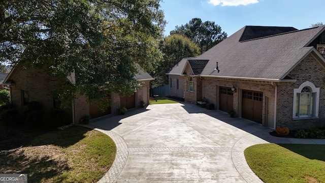 view of side of home with a garage and a lawn