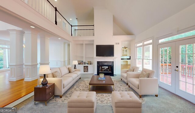 15 Greenridge Way, Newnan, GA 30265 - living room with a high ceiling, decorative columns, plenty of natural light, and a fireplace with flush hearth