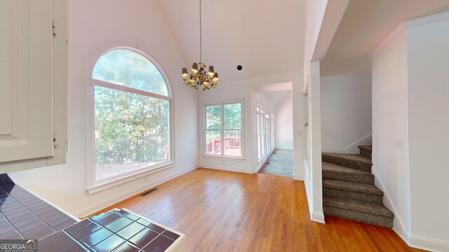 15 Greenridge Way, Newnan, GA 30265 - interior space featuring a chandelier, stairs, baseboards, wood finished floors, and visible vents