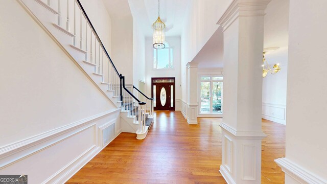 15 Greenridge Way, Newnan, GA 30265 - entrance foyer with an inviting chandelier, wainscoting, a decorative wall, stairway, and light wood finished floors