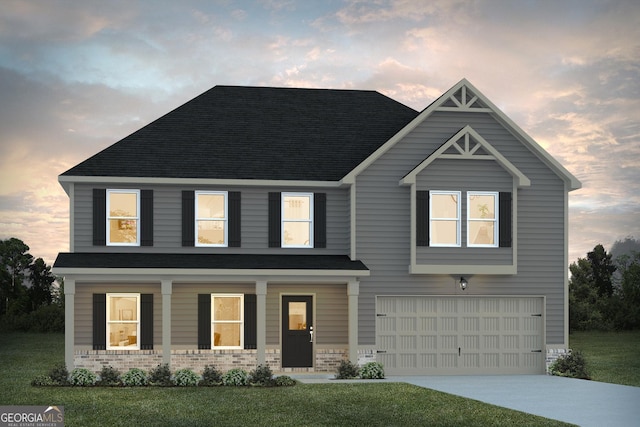 view of front of house featuring a yard and a garage