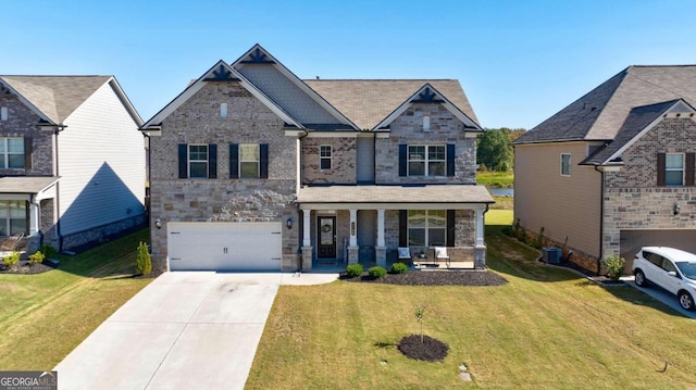 craftsman-style home with a front lawn, a garage, and covered porch