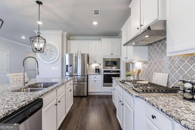 kitchen featuring white cabinetry, sink, decorative light fixtures, and appliances with stainless steel finishes