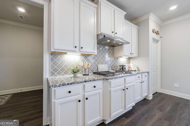 kitchen with white cabinets, dark hardwood / wood-style floors, light stone counters, and crown molding