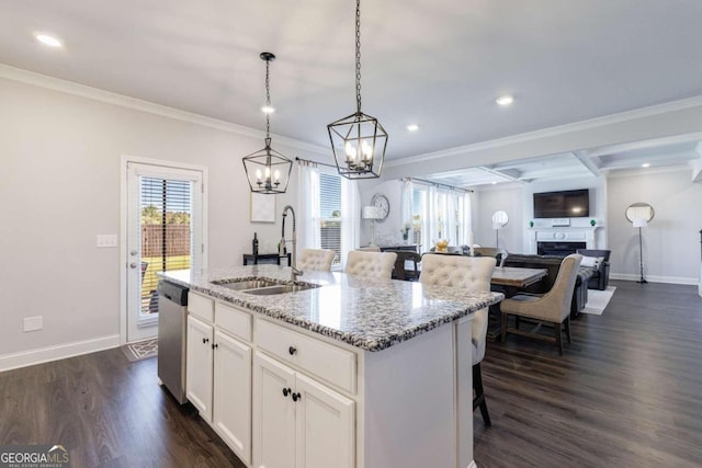 kitchen featuring a center island with sink, dark hardwood / wood-style floors, sink, white cabinets, and stainless steel dishwasher