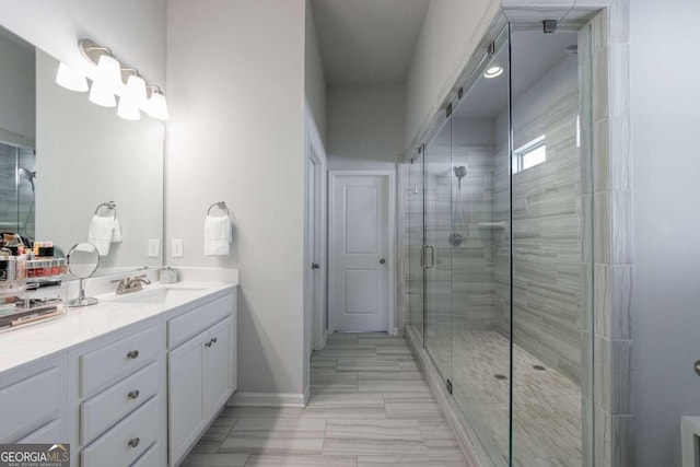 bathroom featuring vanity and a shower with shower door