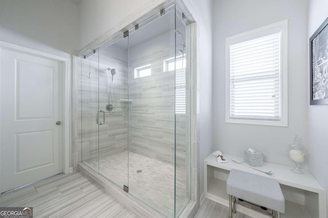 bathroom featuring a shower with shower door