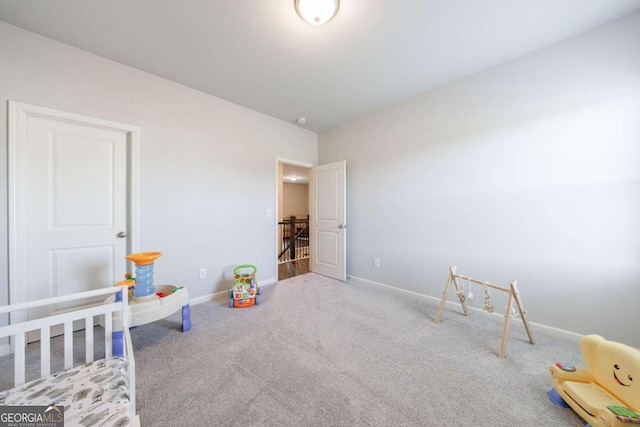 carpeted bedroom with a nursery area