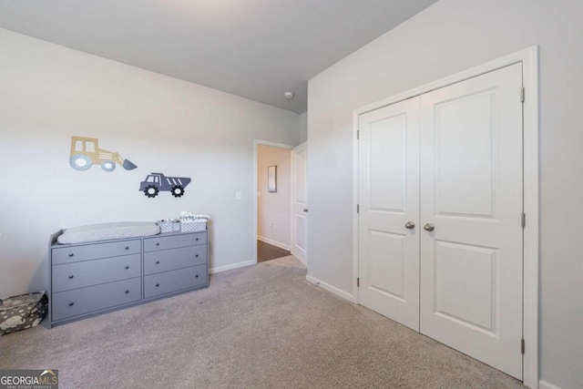 unfurnished bedroom featuring light carpet and a closet