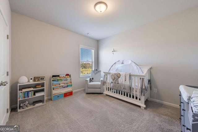 carpeted bedroom featuring a crib