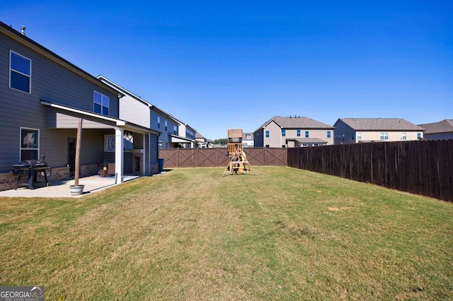 view of yard featuring a playground and a patio area