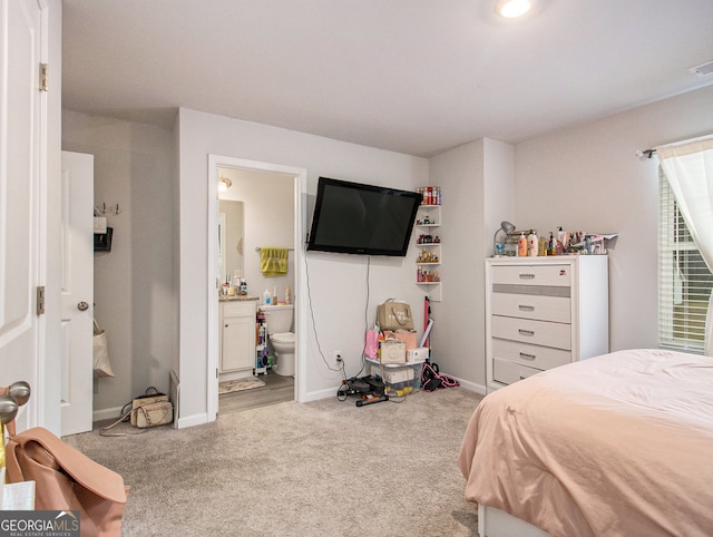 carpeted bedroom with ensuite bathroom