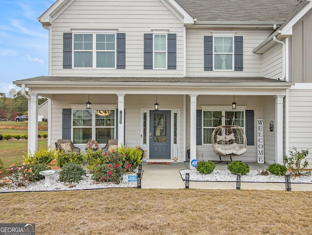 view of front facade with a porch and a front lawn