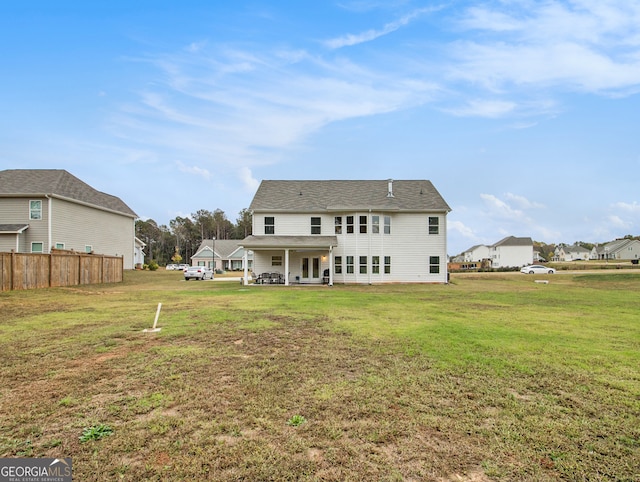 back of house with a yard