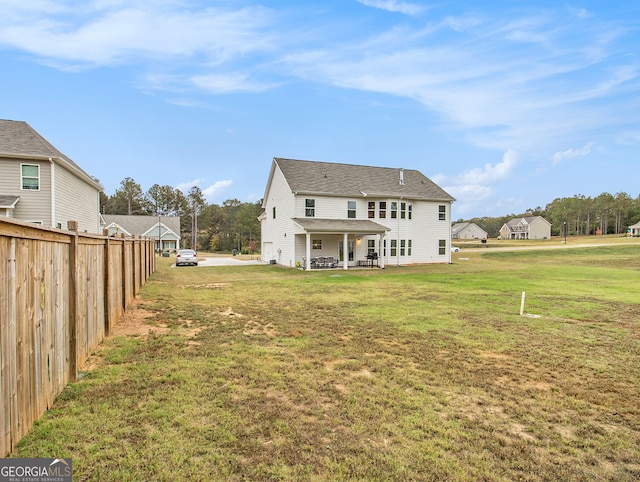 back of property featuring a lawn