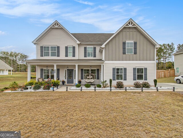 view of front of home with a front yard and covered porch