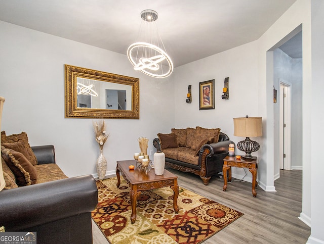 living room featuring an inviting chandelier and light wood-type flooring