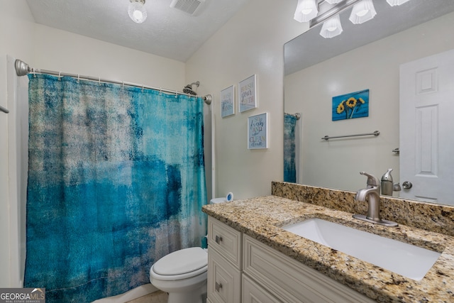 bathroom featuring vanity, toilet, a textured ceiling, and a shower with curtain