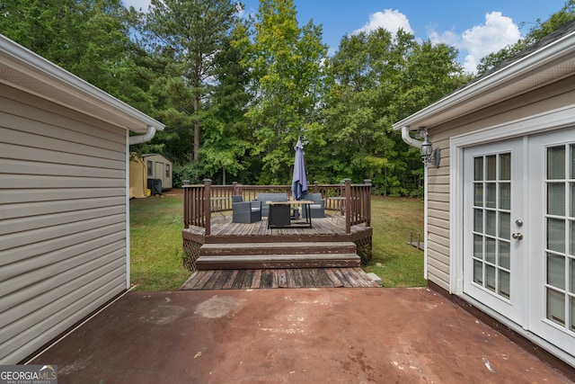 view of patio featuring a deck and a storage unit