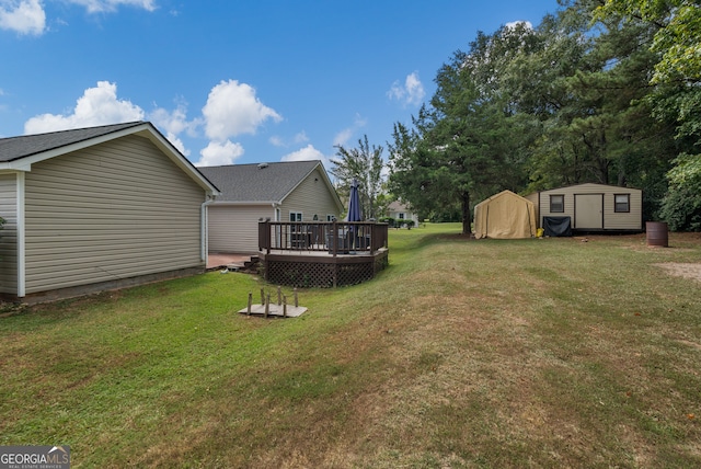 view of yard featuring a wooden deck and a storage shed