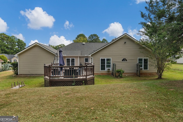 back of property with a deck and a yard