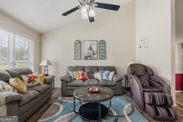 living room featuring dark hardwood / wood-style floors, ceiling fan, and vaulted ceiling