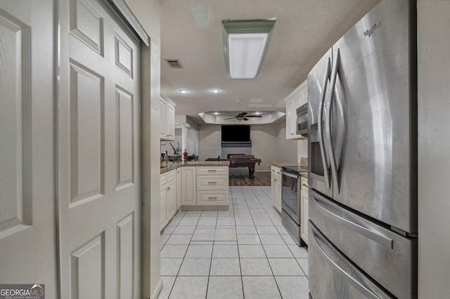 kitchen featuring ceiling fan, appliances with stainless steel finishes, billiards, and white cabinets