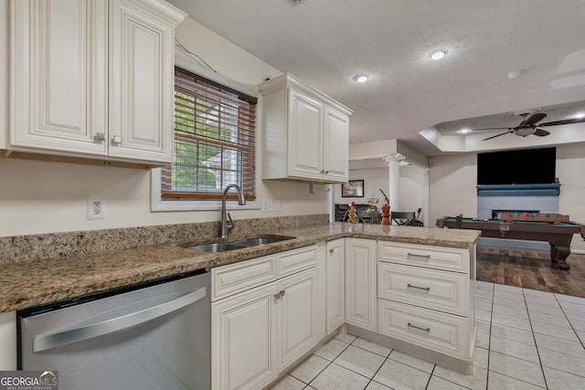 kitchen with pool table, kitchen peninsula, sink, light tile patterned floors, and stainless steel dishwasher