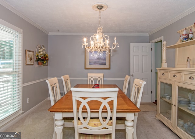 dining room with light colored carpet, ornamental molding, a chandelier, and a textured ceiling