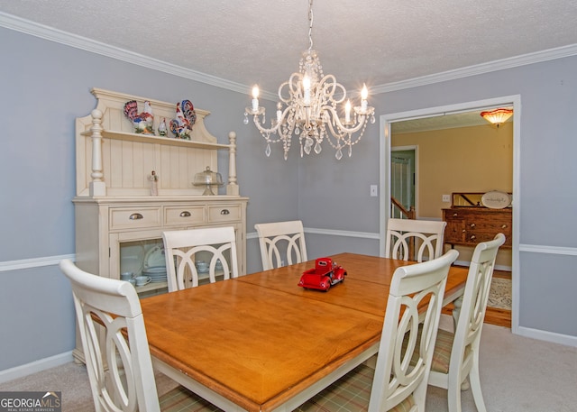 carpeted dining space with a notable chandelier, a textured ceiling, and ornamental molding