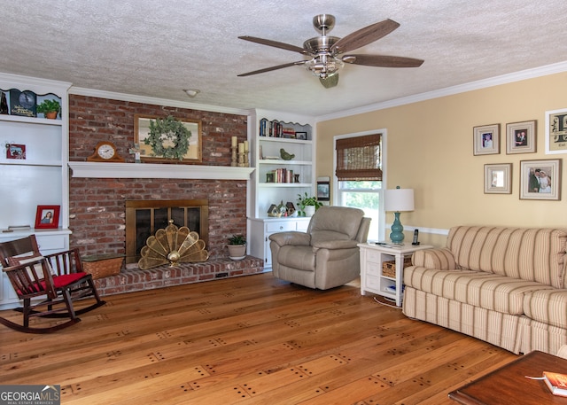 living room with ornamental molding, a textured ceiling, and wood-type flooring