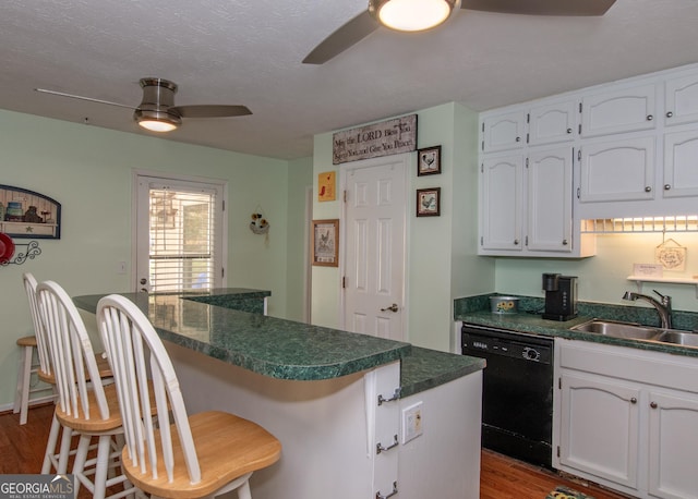 7 Stonehaven Dr, Newnan, GA 30265 - kitchen featuring dishwasher, a ceiling fan, a sink, dark countertops, and white cabinets