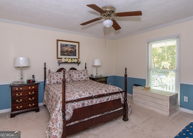 carpeted bedroom with ceiling fan, a textured ceiling, and ornamental molding