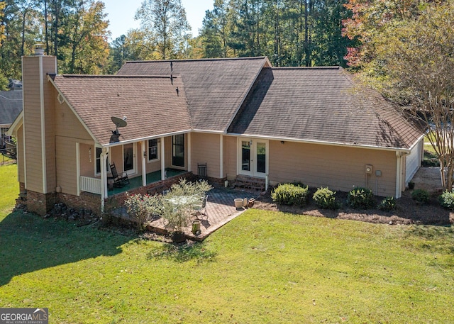 7 Stonehaven Dr, Newnan, GA 30265 - view of front facade featuring a chimney, a front yard, a patio area, a shingled roof, and french doors