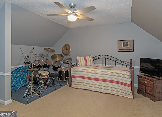 bedroom with ceiling fan, a textured ceiling, carpet, and vaulted ceiling