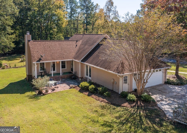 single story home with a garage and a front lawn