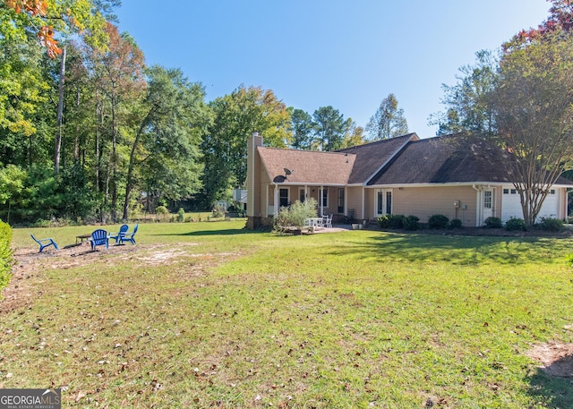 7 Stonehaven Dr, Newnan, GA 30265 - back of house featuring a chimney, a lawn, and a patio area