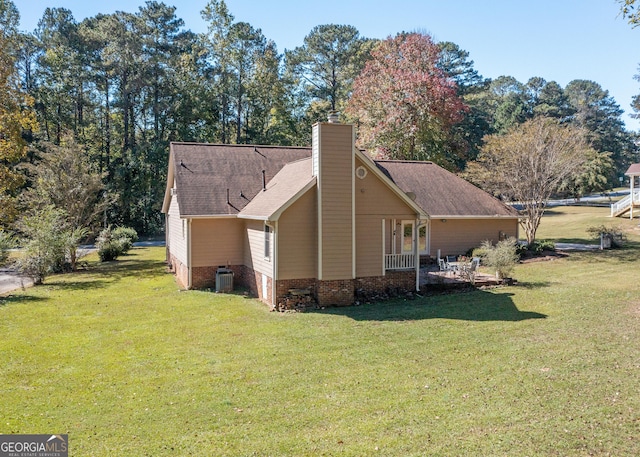 7 Stonehaven Dr, Newnan, GA 30265 - view of side of home with a yard, cooling unit, a chimney, and roof with shingles