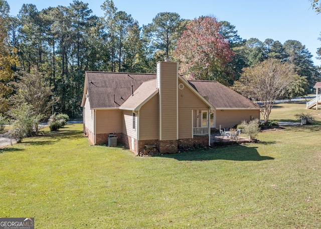 view of property exterior featuring a lawn and central AC unit