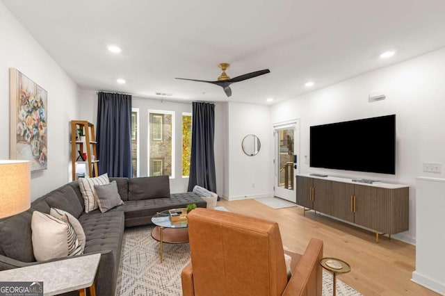 living room with ceiling fan and light hardwood / wood-style floors