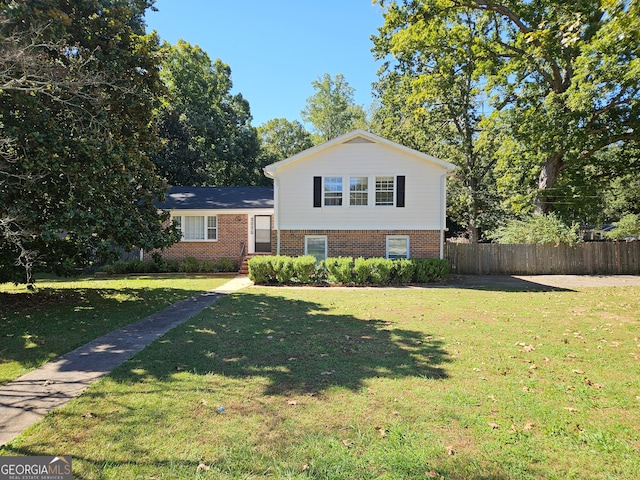 split level home with a front lawn