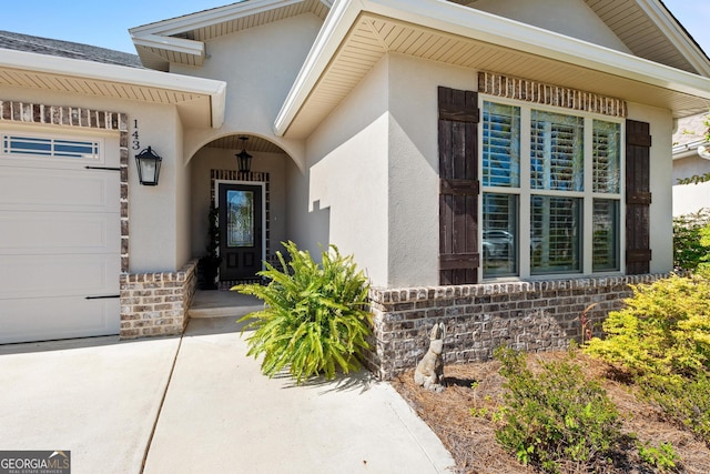 doorway to property with a garage