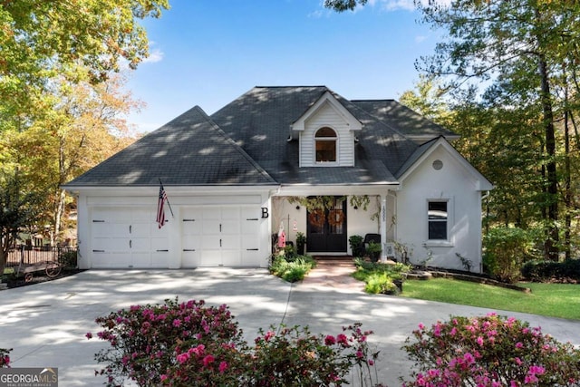 cape cod house featuring a porch and a garage